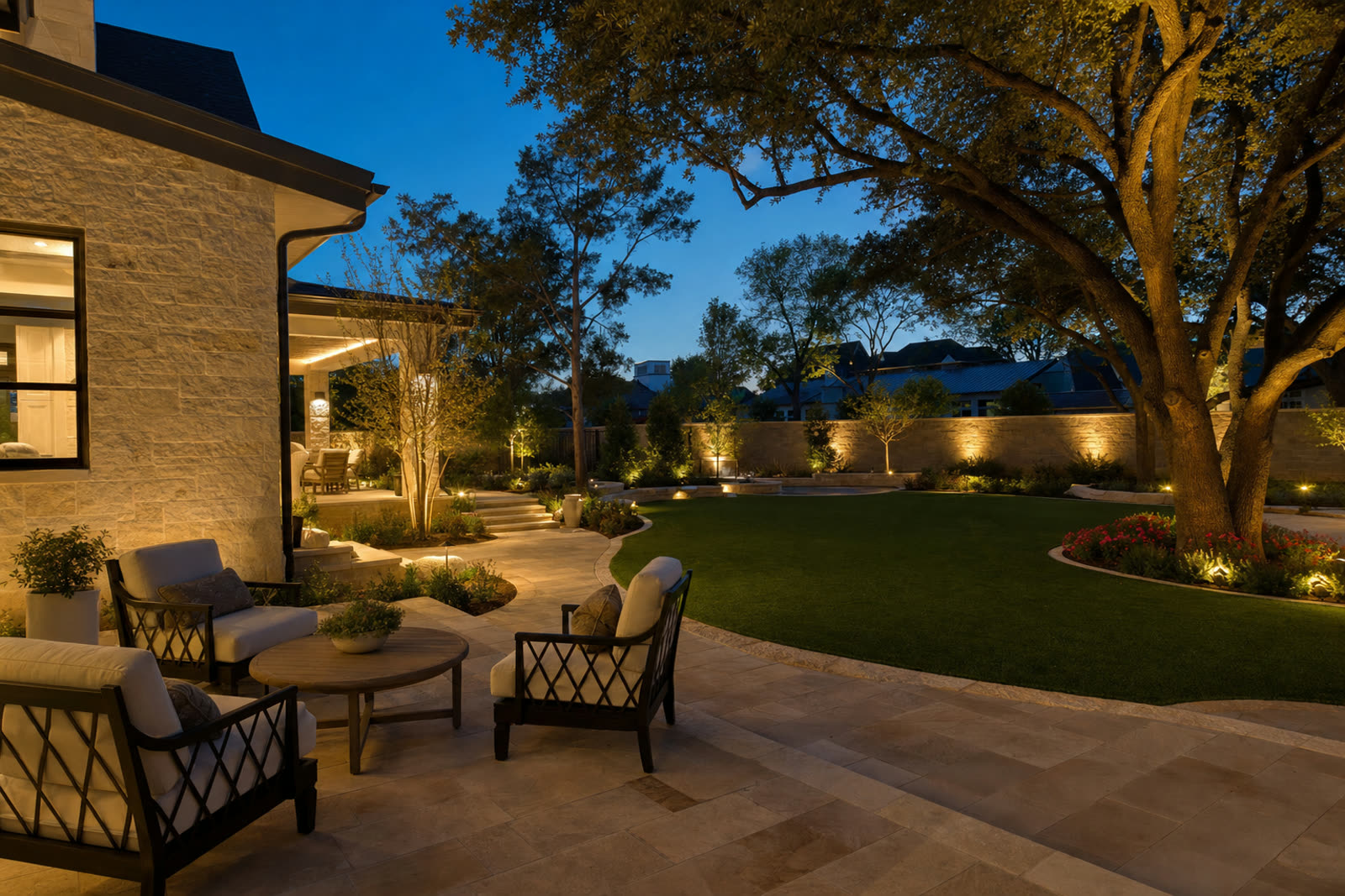 Completed backyard landscape project with patio, turf and lighting